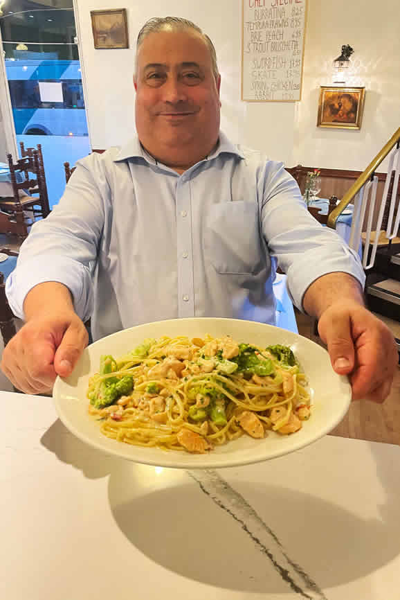 Chef pesenting freshly prepared Spaghetti Carbonara